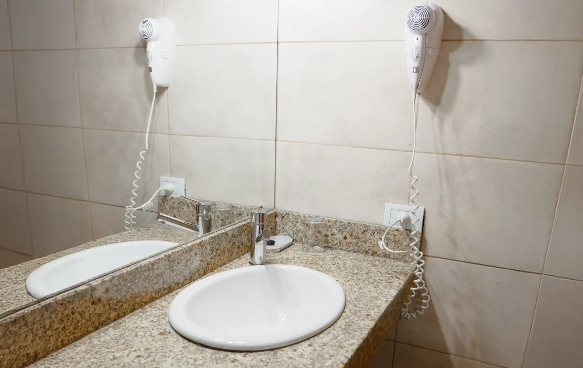 Baño con bacha integrada, espejo y secador de pelo, correspondiente a la Casa 4