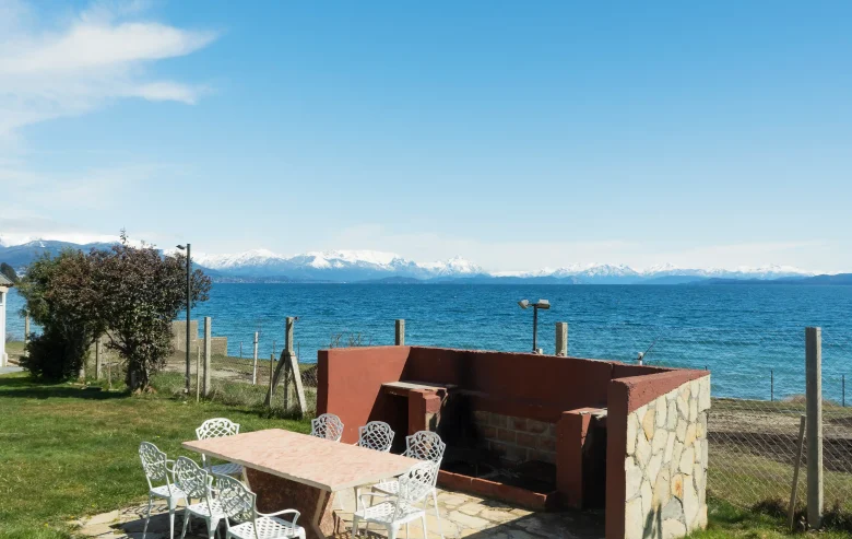 Sector parrilla con mesa y 8 sillas y vista al lago y montañas